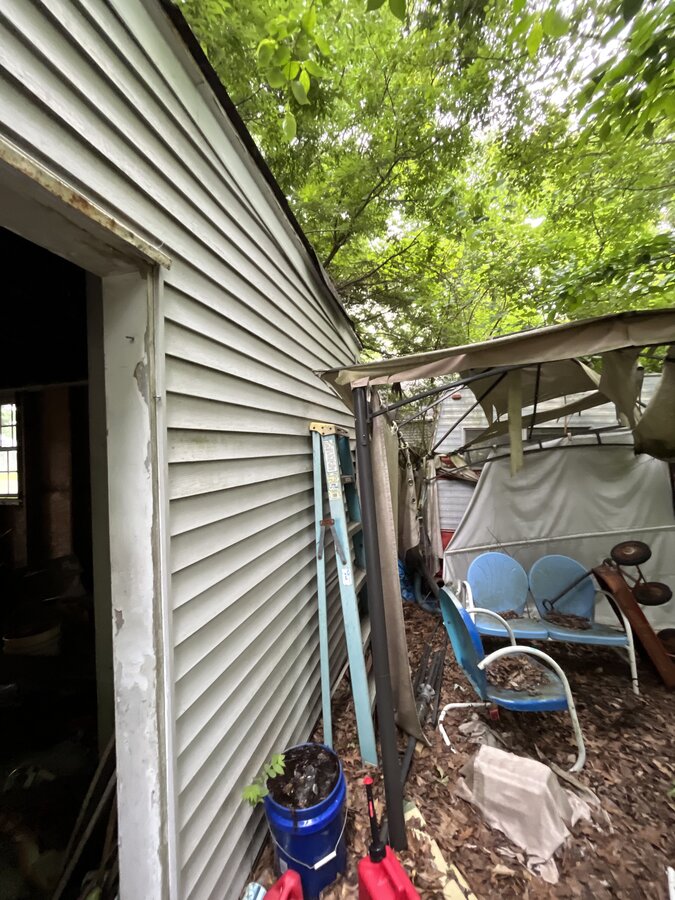 Columbus OH before — rear exterior showing severe deferred maintenance