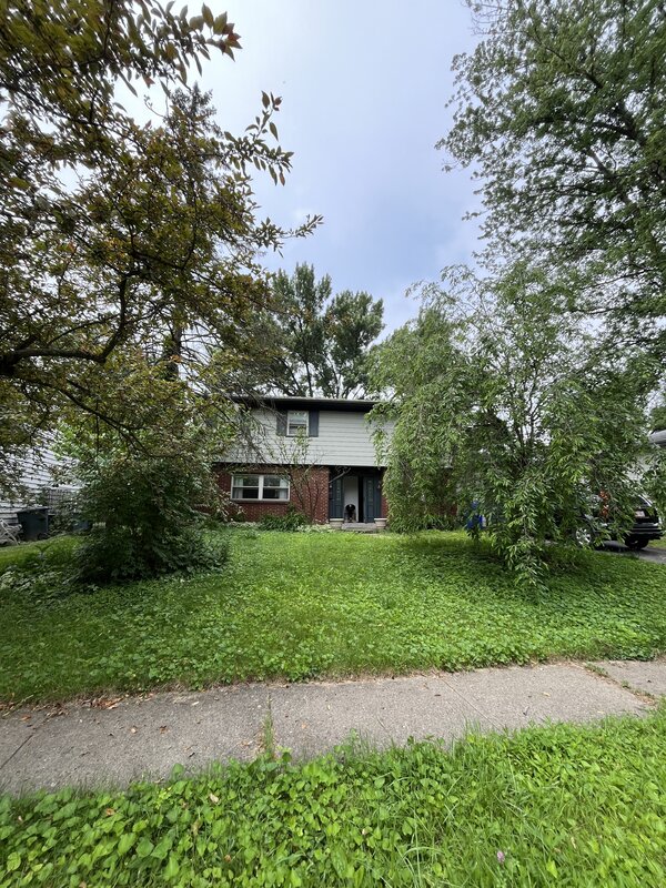 Columbus OH home before purchase — overgrown yard and deferred maintenance