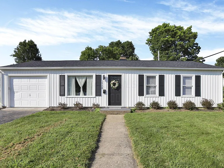 Lancaster OH home after — white board-and-batten with black shutters
