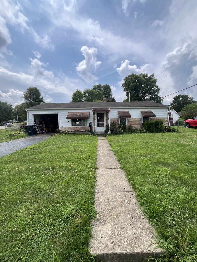 Lancaster OH rental home before — dated ranch with rusted awnings